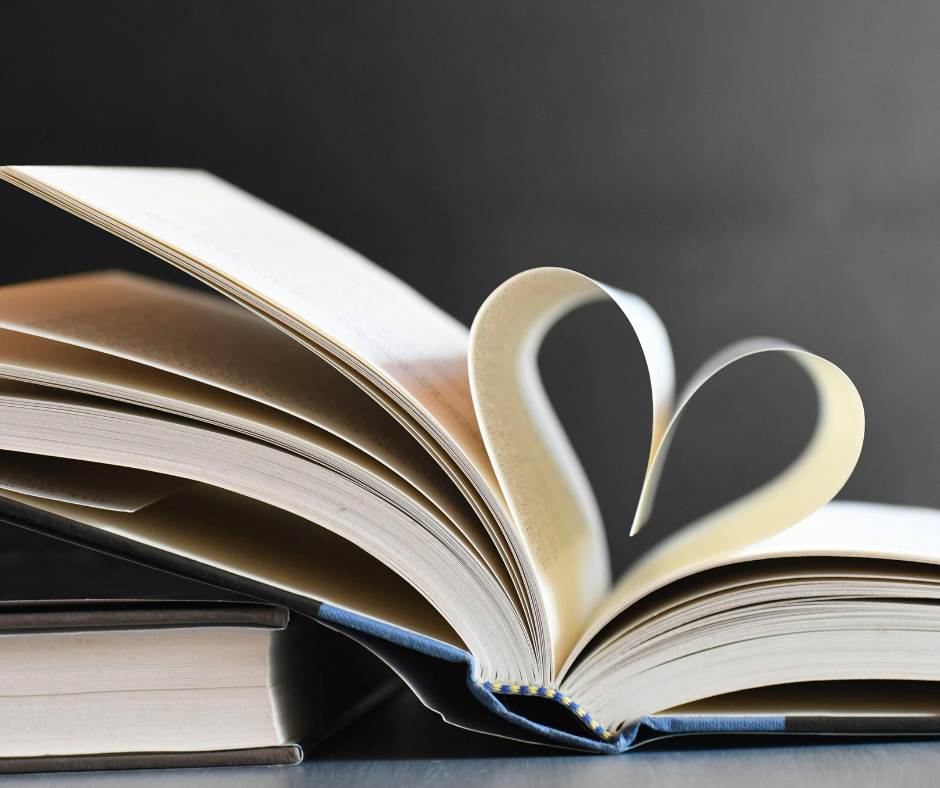 Open book with pages folded into a heart shape